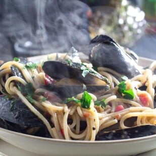 Steaming Low FODMAP Pasta with Mussels in a white bowl