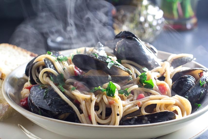 Steaming Low FODMAP Pasta with Mussels in a white bowl