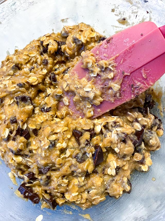 Stir cookie dough for one-bowl low FODMAP peanut butter oatmeal chocolate chunk cookies together once you have added chocolate and raisins