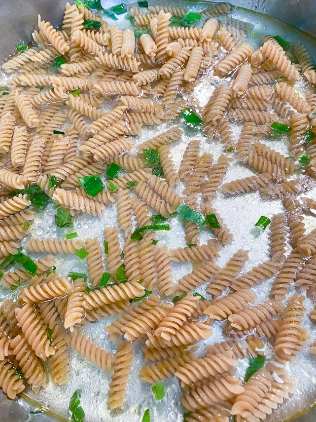 Stir pasta and water into pan for one pan low FODMAP pasta & vegetables
