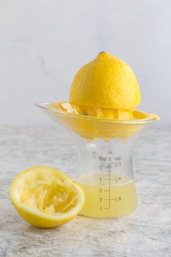 Using a lemon reamer to extract lemon juice for Low FODMAP Lemon Salad Dressing