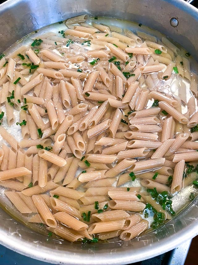 low FODMAP Pasta Primavera cooking; adding pasta and water