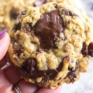 one bowl low FODMAP oatmeal peanut butter chocolate chunk cookies held in hand