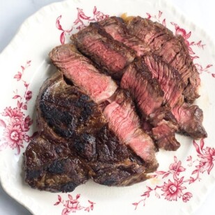 No FODMAP Steak on a decorative plate against white background