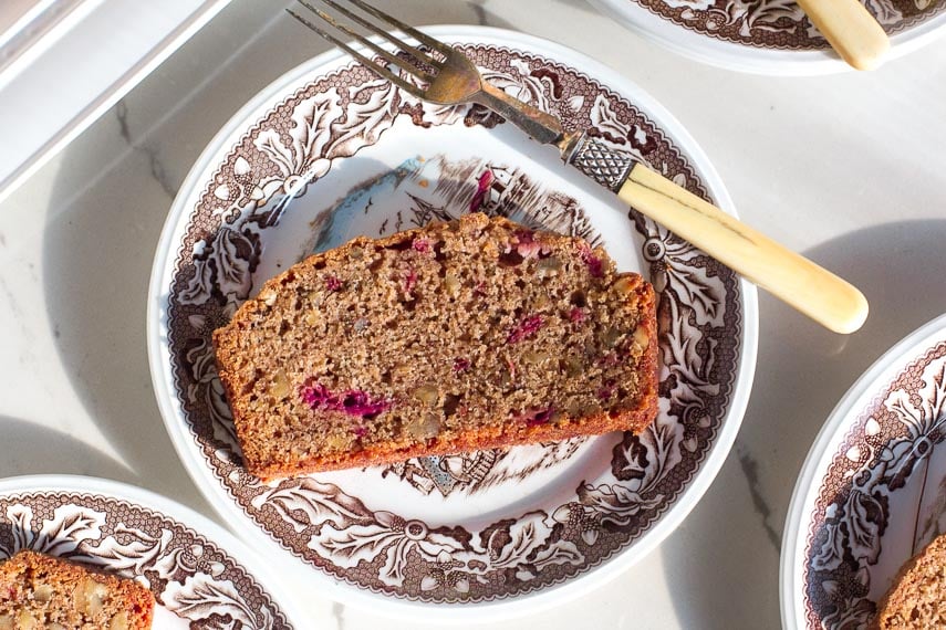 Slice of low FODMAP Strawberry Bread on a brown and white decorative plate
