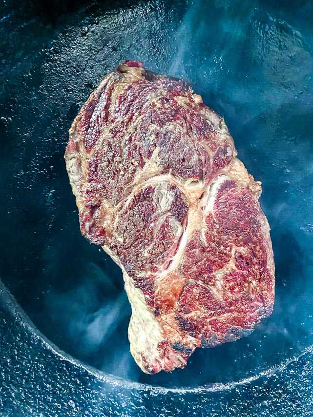 seared steak in cast iron pan