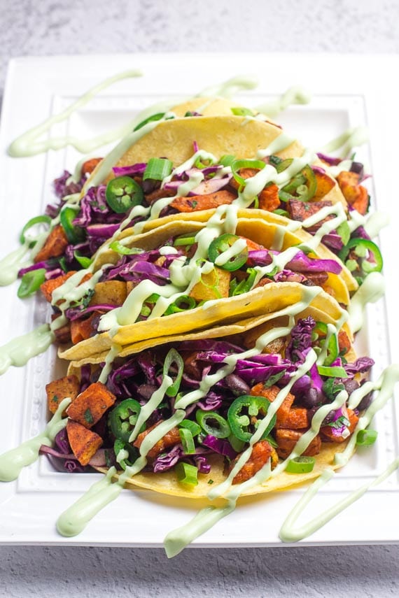 Front shot of low FODMAP sweet potato tacos with black beans and Avocado Lime Crema