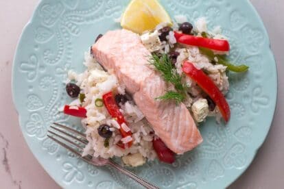 Greek salmon on decorative light white plate on white quartz