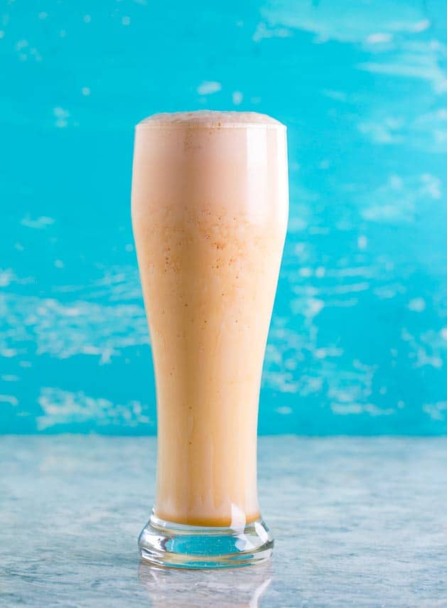 Low FODMAP Orange Carrot Juice with protein powder added in tall glass