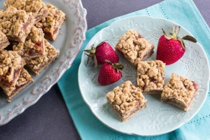 main image of for Nutty Low FODMAP Strawberry Oat Bars on aqua plate and napkin