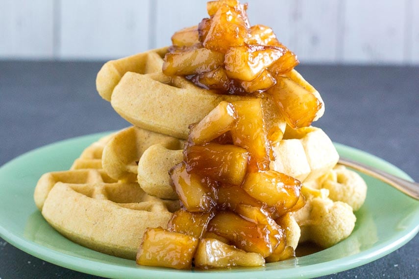 pile of low FODMAP Caramelized Pineapple sauce on waffles and green plate