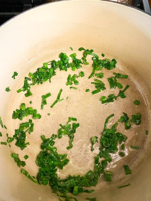 sauteeing scallion greens in large pot for Low FODMAP Chili Mac