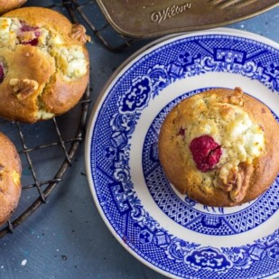 Main image of Low FODMAP Olive Oil Muffins with Goat Cheese, Walnuts and Raspberries; blue backdrop and blue plate