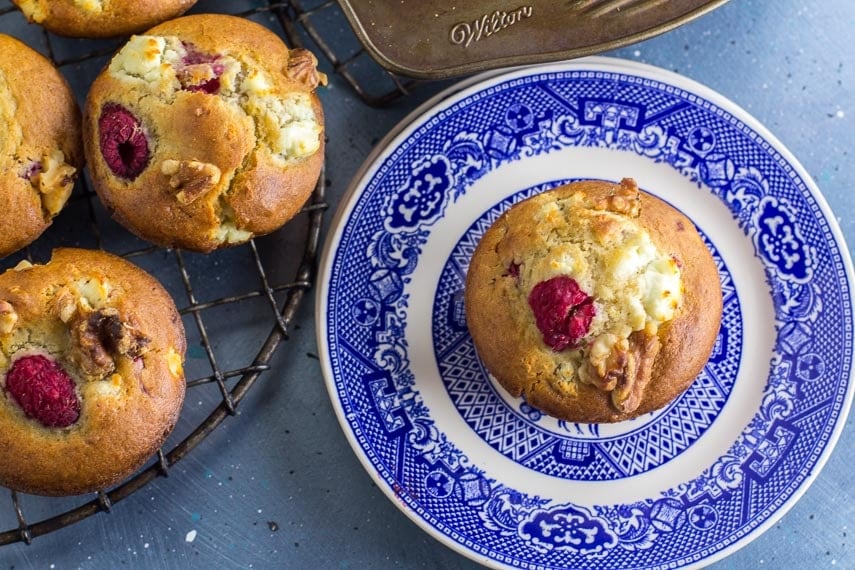 Main image of Low FODMAP Olive Oil Muffins with Goat Cheese, Walnuts and Raspberries; blue backdrop and blue plate