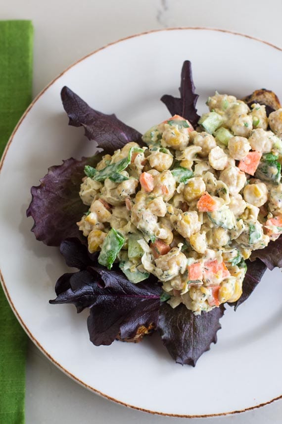 Overhead image of vegan low FODMAP CHICKPEA Salad as an open-faced sandwich on LOFO bread; green napkin