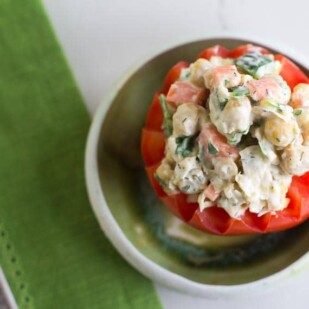 Overhead image of vegan low FODMAP CHICKPEA Salad stuffed into a tomato; green napkin
