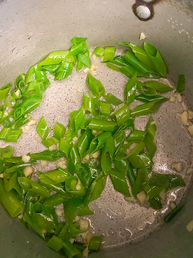 cooking scallions and ginger for kimchi stew