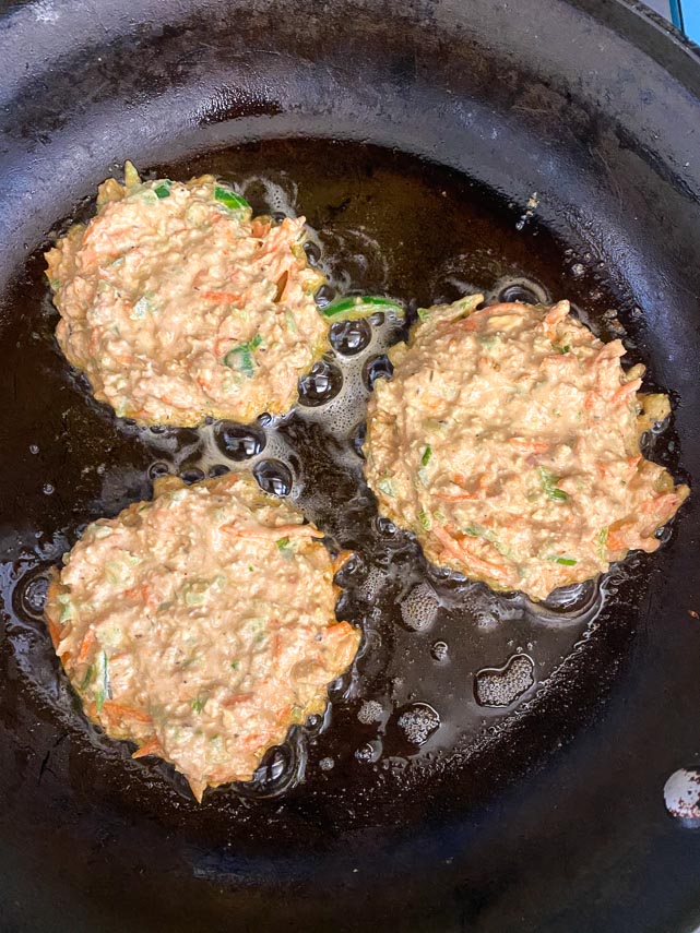 tuna patties frying in pan