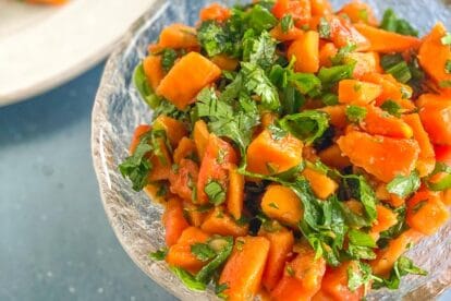 Low FODMAP Papaya Salsa in clear bowl in blue surface; very closeup image