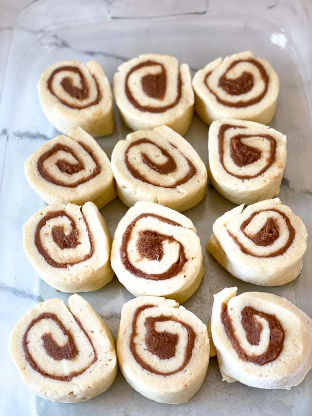 cinnamon rolls, cut and nestled in prepared pan ready to bake