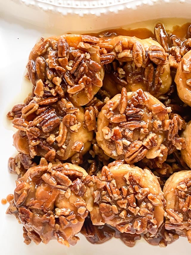 closeup of low FODMAP gluten-free caramel pecan sticky buns on white platter