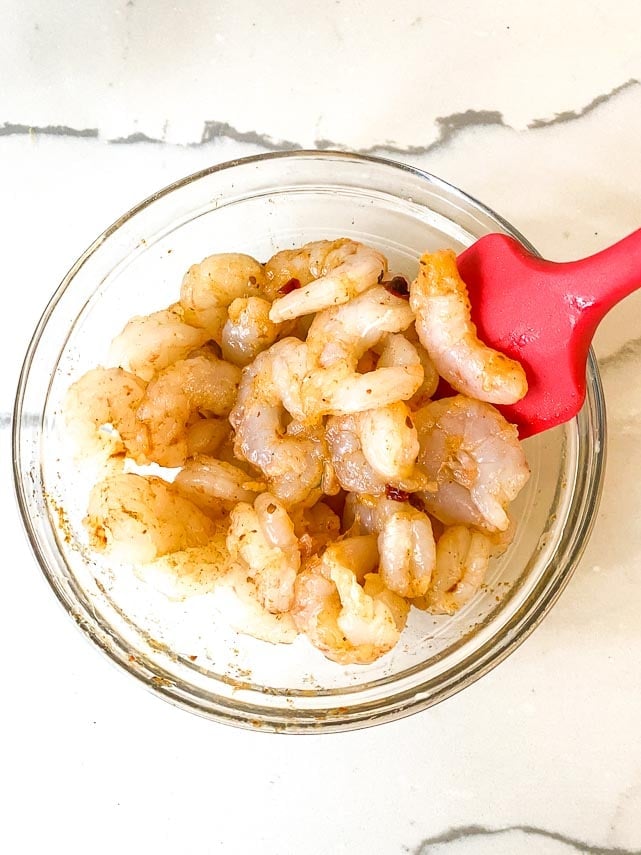 coating raw shrimp with spices for shrimp tacos