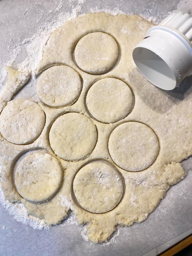 cutting out jelly donut dough with a round cutter