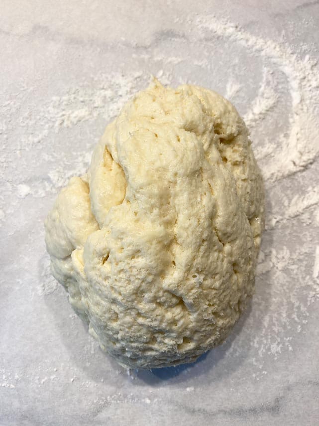 jelly donut dough on lightly floured surface, ready to roll out