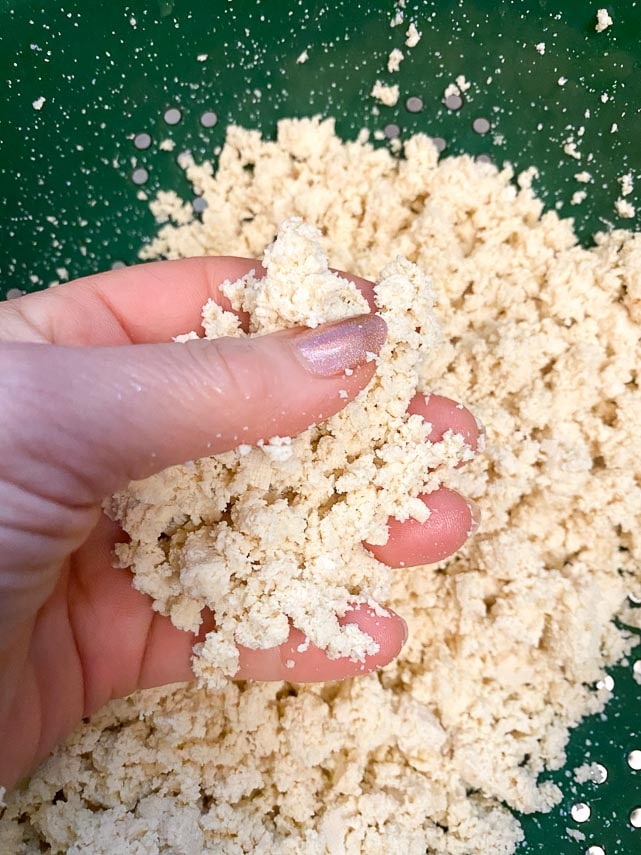 keep crumbling tofu until it is an evenly crumbled texture, then press as much water out of it as possible. It should feel dry and almost fluffy