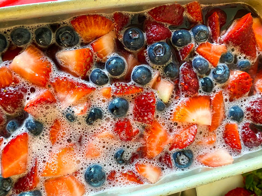 liquid gelatin poured over fruit in loaf pan; bubbles are from lime seltzer