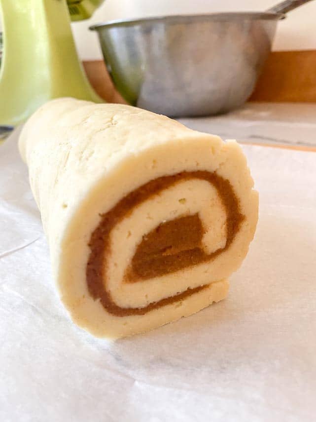 log of cinnamon rolls ready to be cut