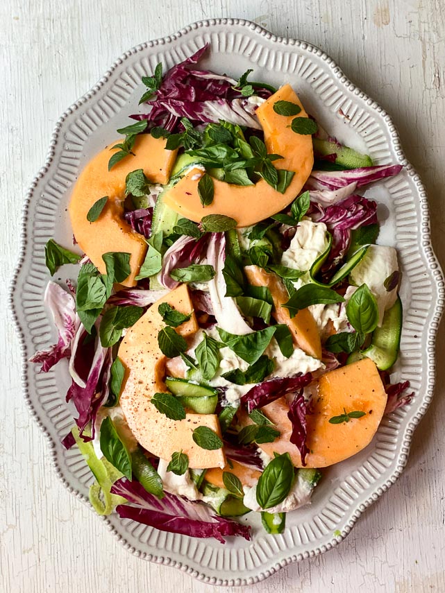 low FODMAP cantaloupe, cucumber and burrata salad on an oval platter