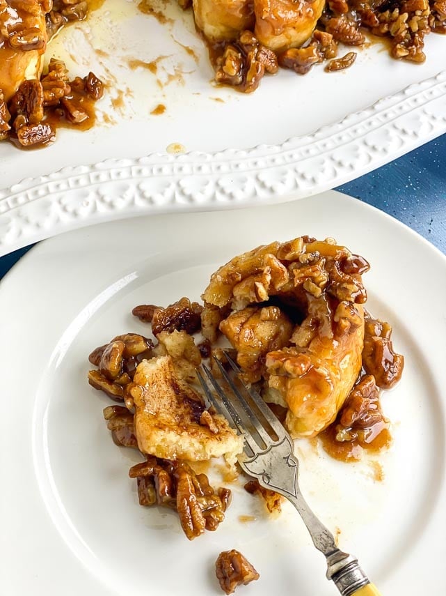 low FODMAP gluten-free caramel pecan sticky buns on white plate with fork