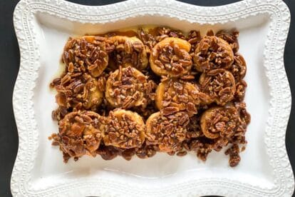 overhead low FODMAP gluten-free caramel pecan sticky buns on decorative white platter