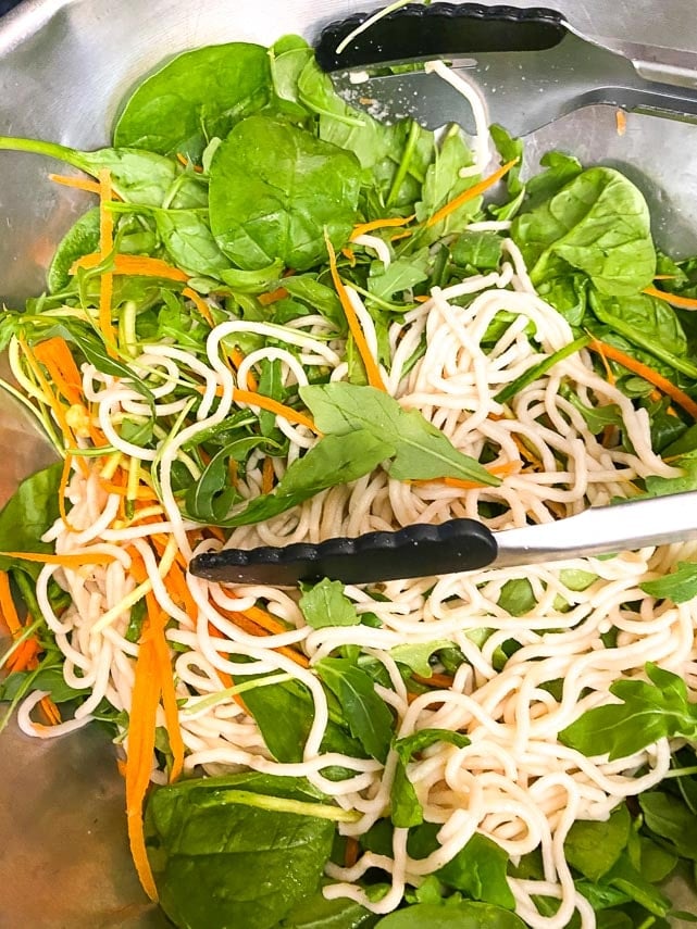 tossing ingredients together for Thai Basil Steak Salad