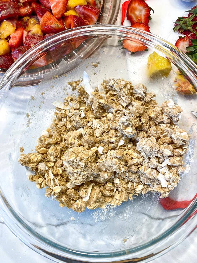vegan oat crisp topping with coconut flakes in clear bowl