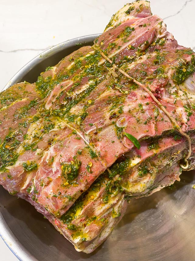 wet marinade slathered on pork roast, showing the underside of the roast