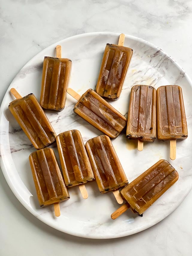 10 low FODMAP Cold Brew Latte Pops on round white marble tray