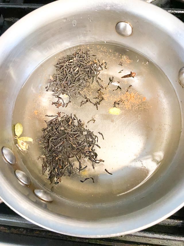 Adding tea to pot for Masala Chai