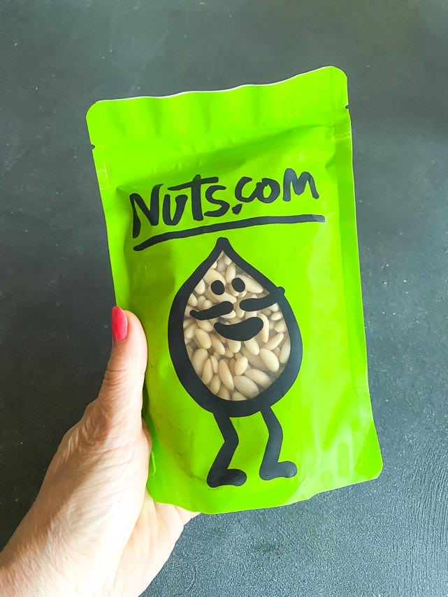 Bag of pine Nuts in green bag held in hand