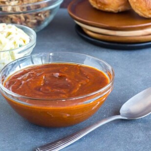 Hot and Tangy BBQ sauce in glass dish with spoon