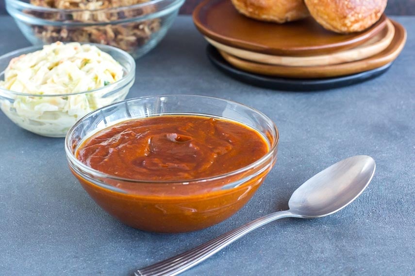 Hot and Tangy BBQ sauce in glass dish with spoon
