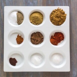 Low FODMAP Cumin Allspice Dry Rub ingredients in white dish with separate compartments