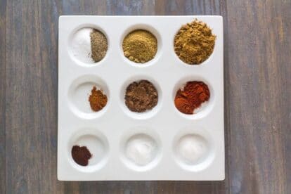 Low FODMAP Cumin Allspice Dry Rub ingredients in white dish with separate compartments