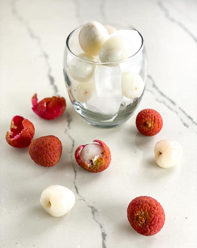 Lychees in a glass with ice cubes, ready to eat