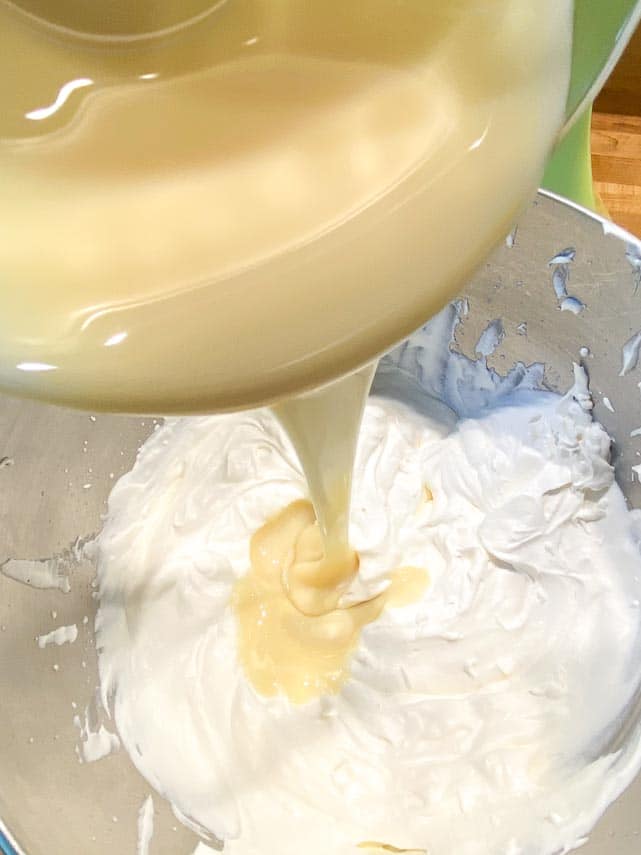 adding sweetened condensed milk to whipped cream