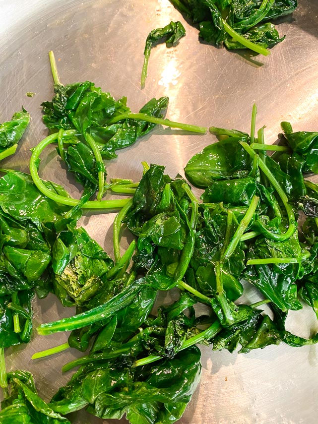 baby kale greens cooked down in sauté pan
