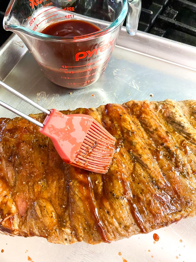 coating ribs with BBQ sauce