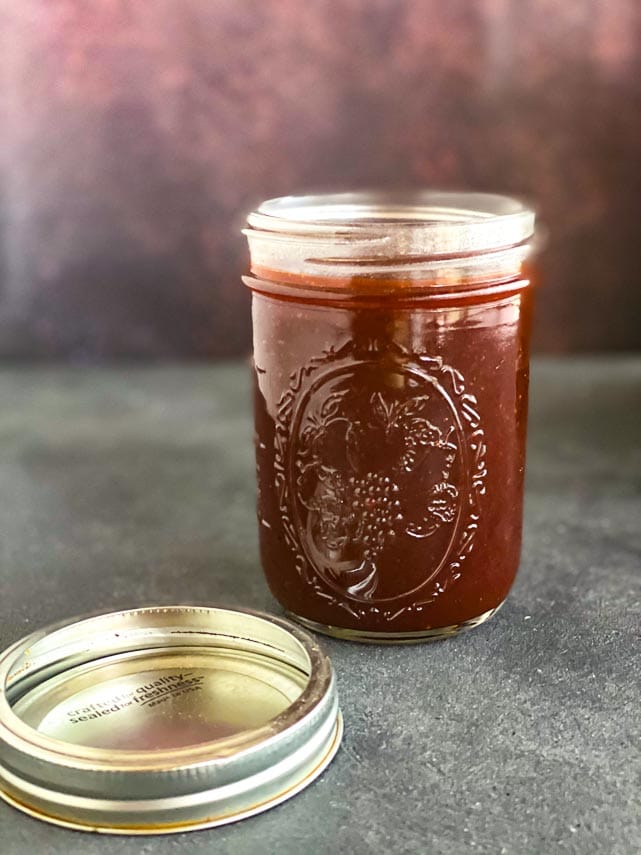low FODMAP sweet and sticky BBQ sauce in a glass jar, lid on the side