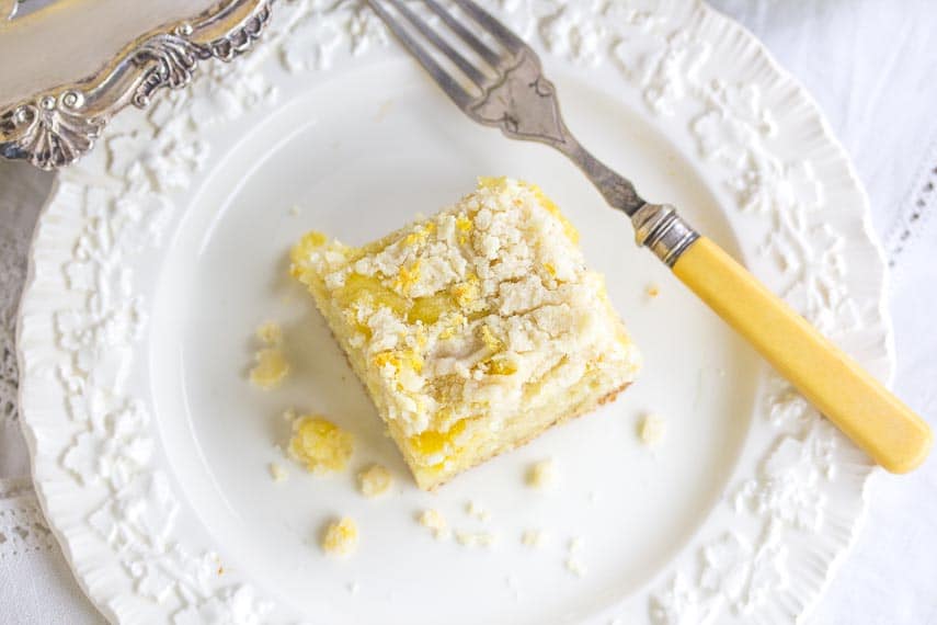 one square of Low FODMAP Lemon Crumb Cake on a white plate with antique fork